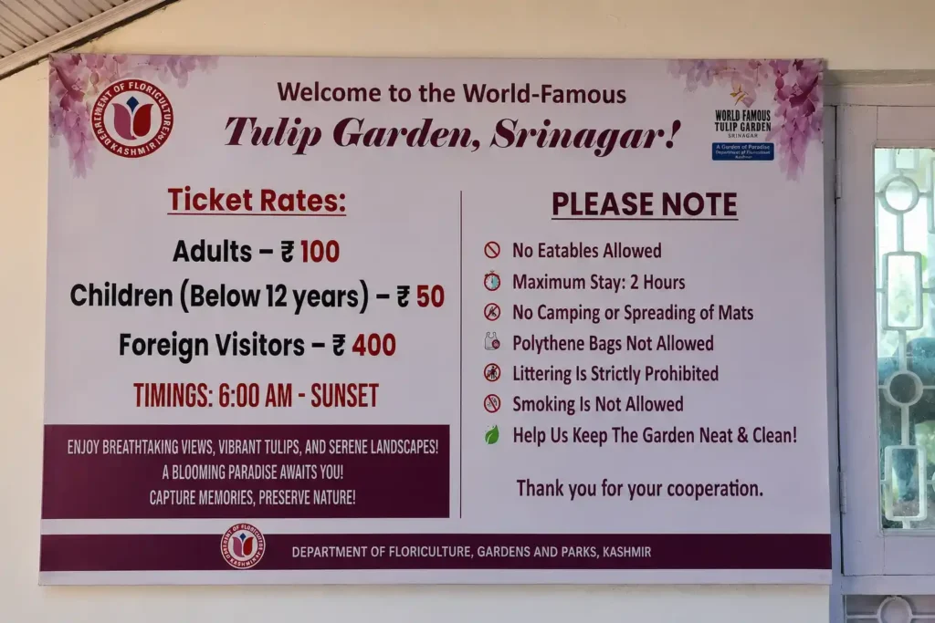 Ticket rates and visitor guidelines displayed at the Indira Gandhi Memorial Tulip Garden in Srinagar, Kashmir.