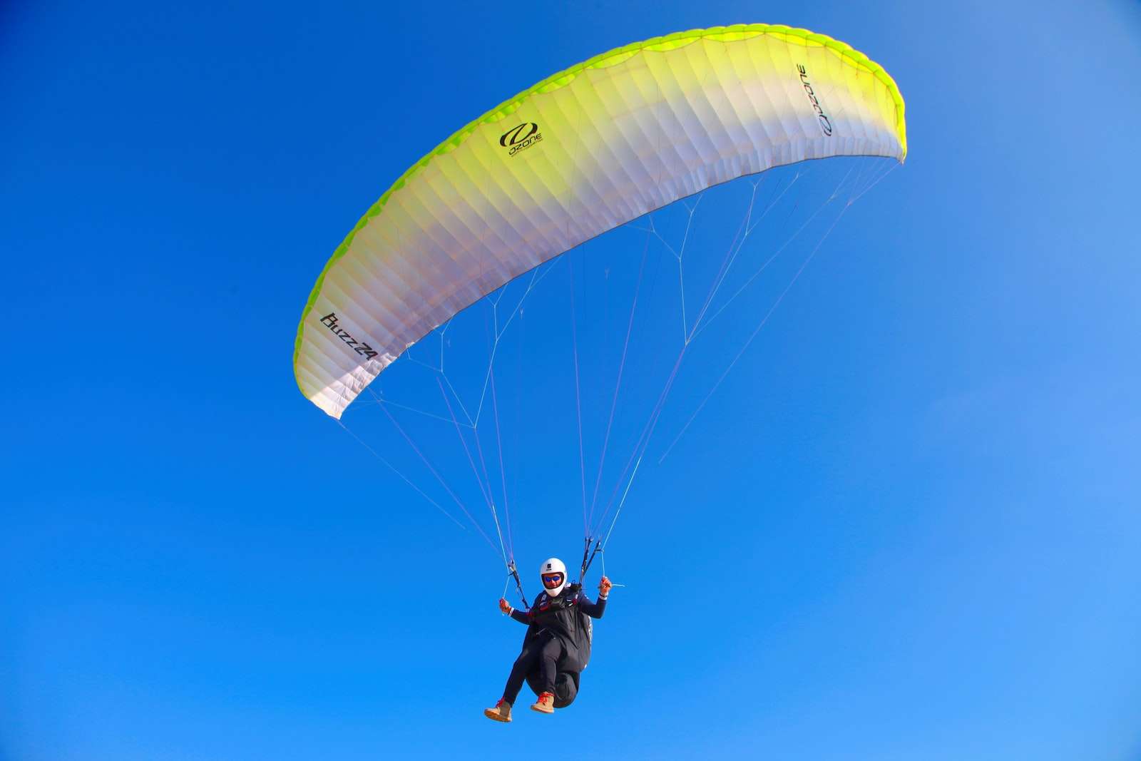 person paragliding in blue sky