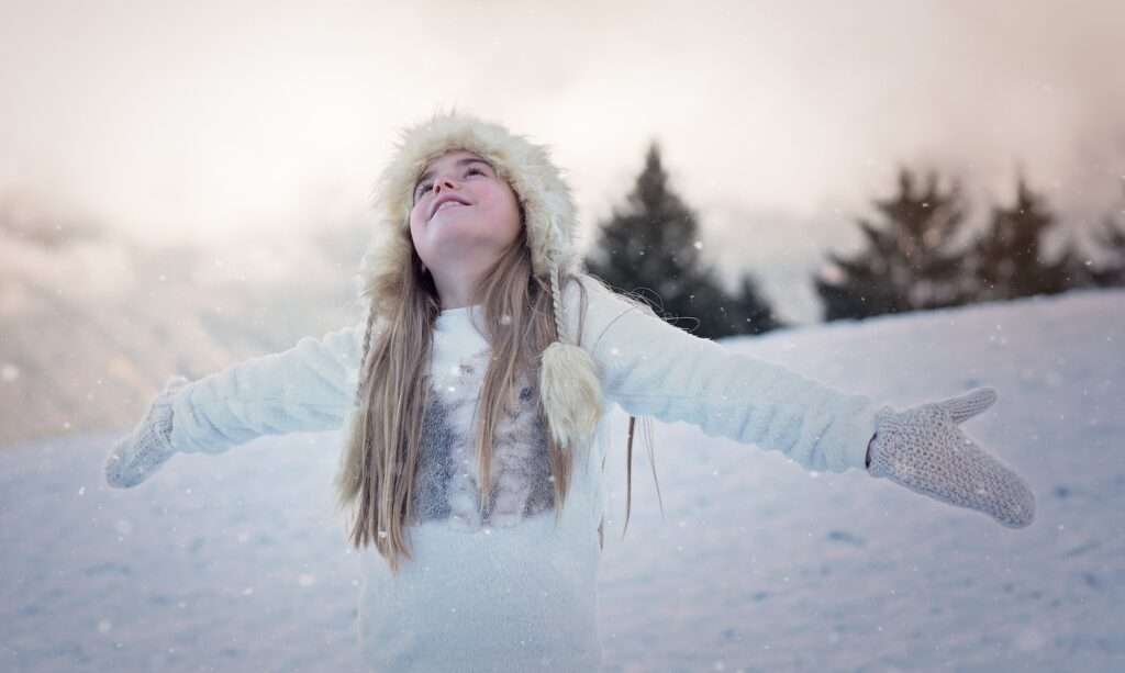 Young Woman enjoying snowfall in kashmir