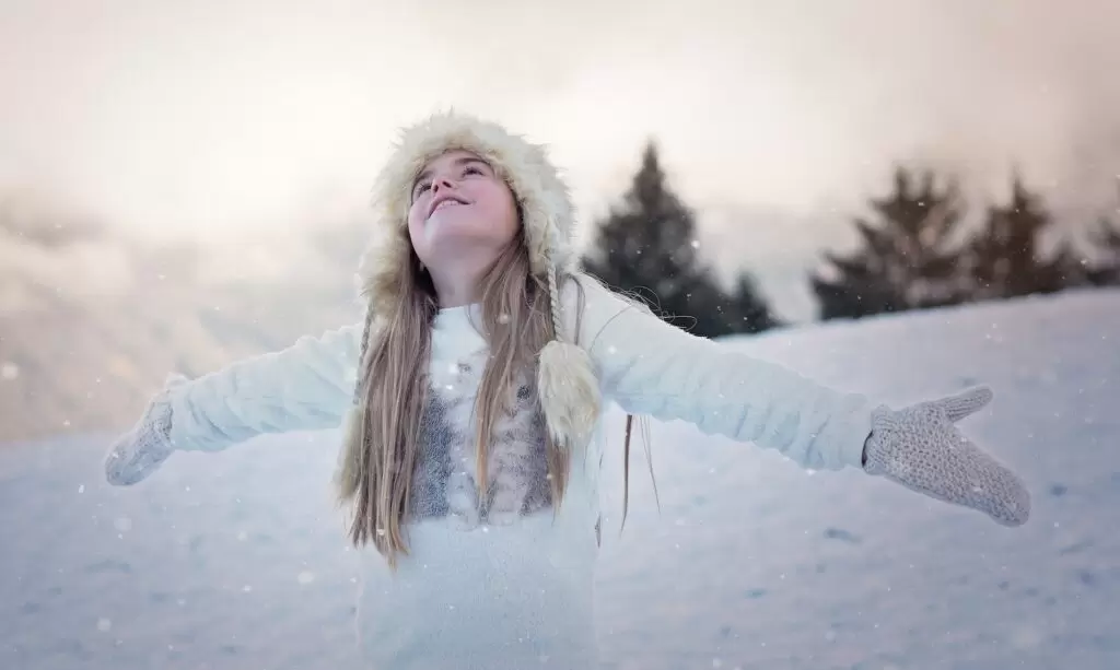 Young Woman enjoying snowfall in kashmir