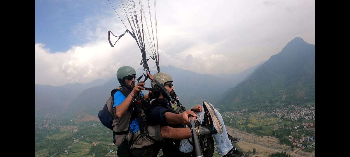 A tourist enjoying Paragliding in srinagar, Travel my Kashmir