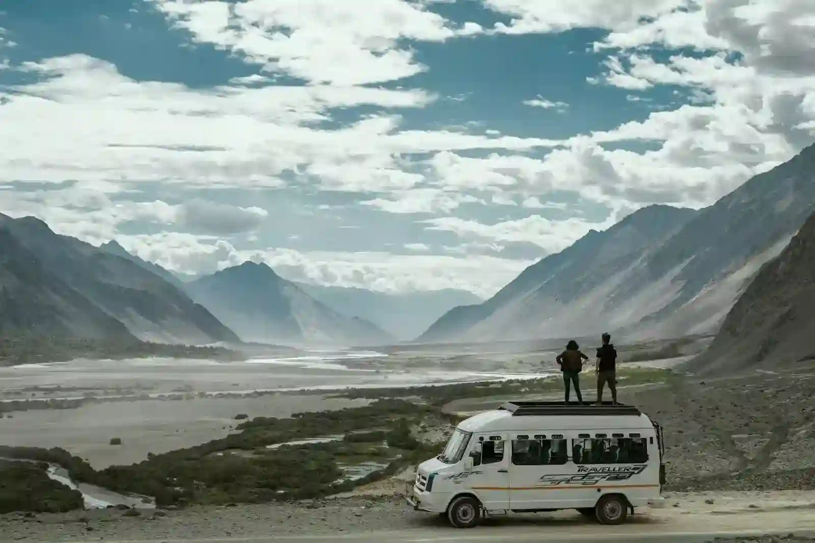 two person on top of white van while Ladakh trip- kashmir leh ladakh tour packages