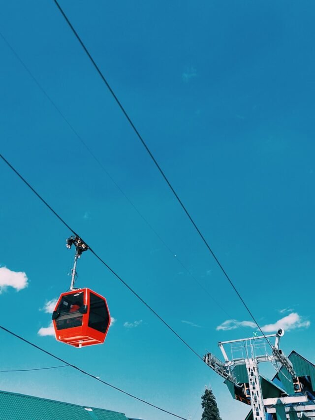 a red ski lift going up a hill