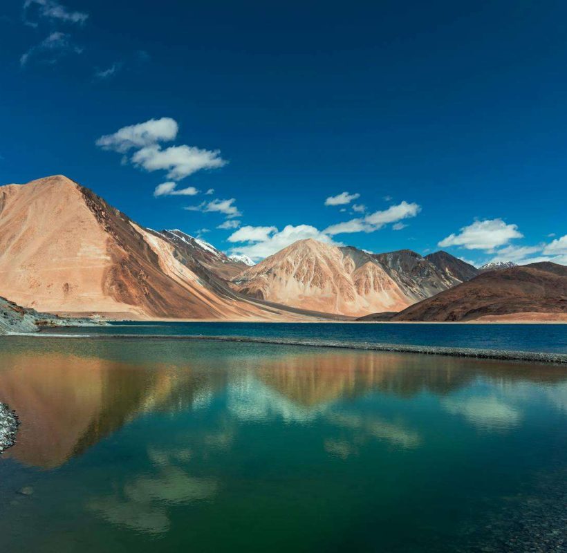 Pangong Lake Near the Mountains Under the Blue Sky and White Clouds - Kashmir leh ladakh tour packages