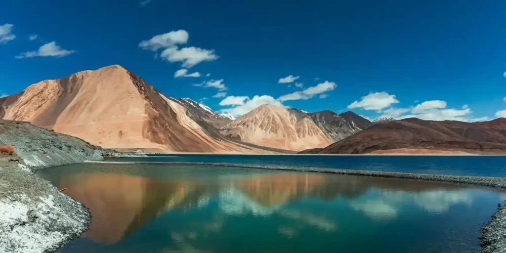 Pangong Lake Near the Mountains Under the Blue Sky and White Clouds - Kashmir leh ladakh tour packages