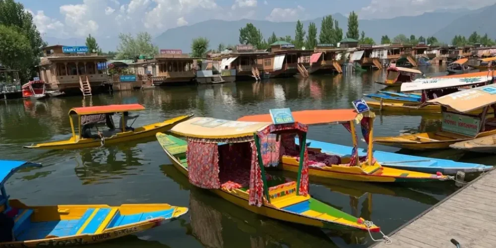 a group of colorful boats floating on top of a river - 5 Myths About Shikara Rides You should Ignore