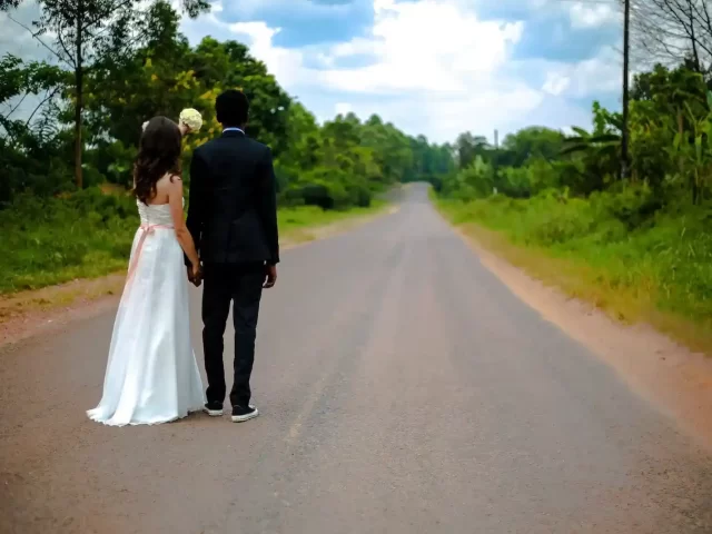 wedding couple standing on winding road in Kashmir