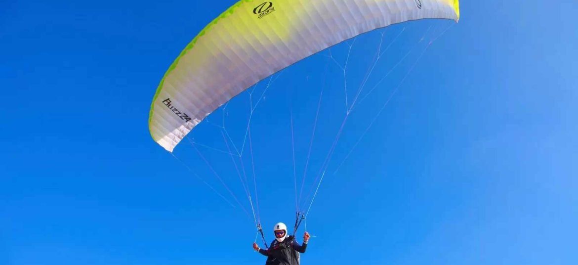 person paragliding in blue sky- Srinagar paragliding