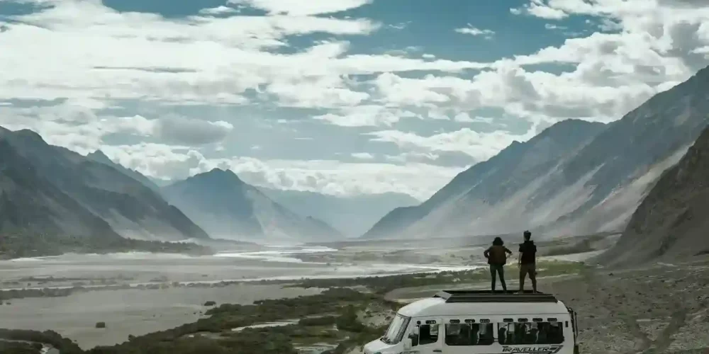 two person on top of white van while Ladakh trip- kashmir leh ladakh tour packages